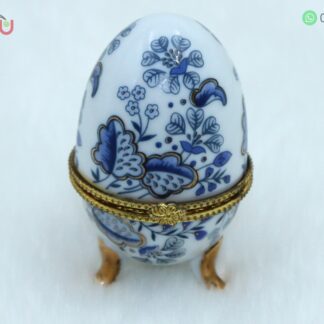 Adorno de porcelana en forma de huevo con filos dorados